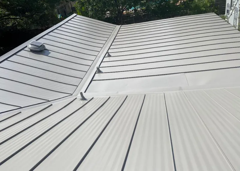 Solar attic fan installed on a metal roof for Roof Ventilation in Merriam